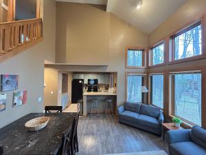 a large living room with a table and a couch at Ski-In 5BR Retreat at Boyne Mtn - Walk to Lifts & Fun! in Boyne Falls