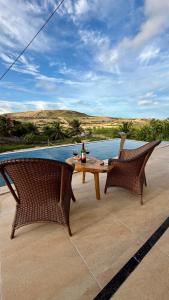 a table and two chairs sitting on a patio at Casa da Duna Moitas-Icaraizinho de Amontada Ceará in Praia de Moitas
