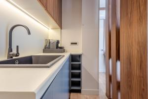 a kitchen with a sink and a counter at Numa Apart-Hotel in Tirana +130 photos