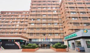 a large brick building with a store in front of it at Apartamentos Resitur in Seville