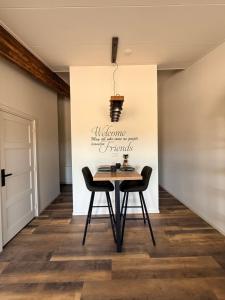 a dining room with a table and two chairs at B&B Goeje Morge in Ammerzoden +13 photos
