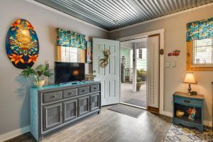 a living room with a television on a dresser at 1 Mi to Ocean Isle Beach! Studio w/ Outdoor Oasis in Ocean Isle Beach