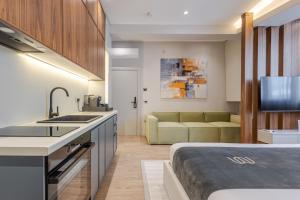 a kitchen with a sink and a couch in a room at Numa Apart-Hotel in Tirana