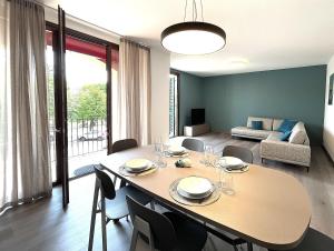 a dining room and living room with a table and chairs at Lake and Rocca Suite in Angera