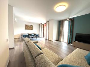a living room with a couch and a dining room at Lake and Rocca Suite in Angera
