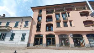a large pink building with a lot of windows at Lake and Rocca Suite in Angera