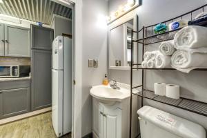 a small bathroom with a sink and a refrigerator at 1 Mi to Ocean Isle Beach! Studio w/ Outdoor Oasis in Ocean Isle Beach +19 photos