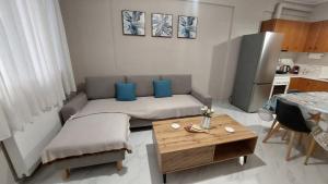 a living room with a couch and a table at Family House Kat in Ioannina