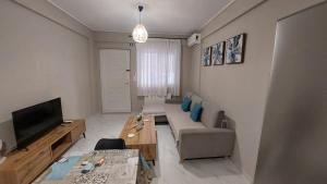 a living room with a couch and a television at Family House Kat in Ioannina