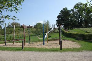 a playground with swings and nets in a park at PONTUS Ferienwohnung FeWo 1 in Zislow