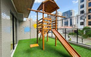 a playground with a swing and a slide at Unigreen Manaíra Genius Flats in João Pessoa