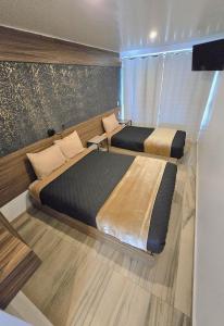 a room with two beds in a room with at Alambique Hotel Express in Arandas +20 photos