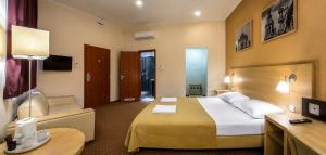 a hotel room with a large bed and a desk at Budapest Citi Guesthouse - contactless self check in in Budapest