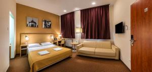 a hotel room with a bedroom with a bed and a couch at Budapest Citi Guesthouse - contactless self check in in Budapest