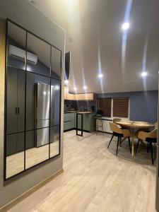 a kitchen and dining room with tables and a refrigerator at Hotel Menchul in Rakhiv +36 photos
