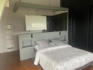 a bedroom with a white bed with two pillows at chambres d hotes ochene in Daix