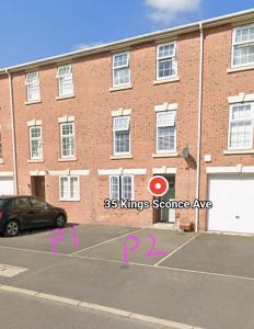 a parking lot in front of a brick building at Kings Sconce in South Muskham