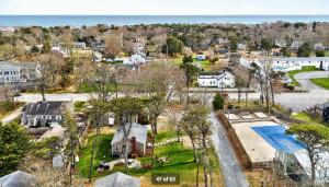 an aerial view of a neighborhood with houses and the ocean at The Coast: Cozy Cape Escape in Dennis Port in Dennis Port