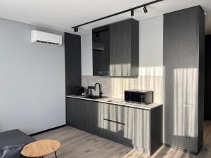 a kitchen with a sink and a microwave at Bavaro apartments 5 in Ivano-Frankivsk