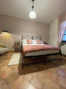 a bedroom with a bed and a couch and a lamp at Liber Barbaresco House in Barbaresco