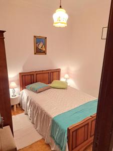 a bedroom with a large bed in a room at Casa da Miquinhas I in Ponte da Barca