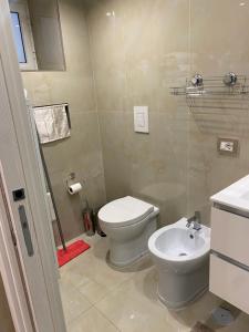a bathroom with a toilet and a sink at Casa Planzio in Naples