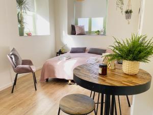a bedroom with a bed and a table and a chair at Modern Studio 1 in Historic Abbey in Cadier en Keer