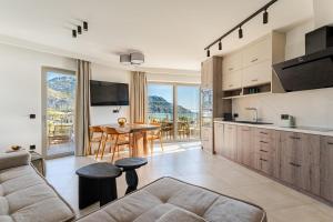 a kitchen and living room with a couch and a table at RIRIKA Beach Living, New Seaside Apartments in Plakias in Plakias