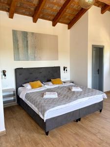 a bedroom with a large bed with yellow pillows at Villa Francesca with Private Pool & Designer Interior in Kaštel +54 photos