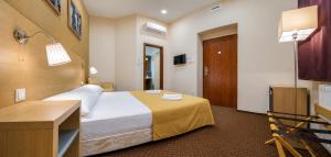 a hotel room with a bed and a desk at Budapest Citi Guesthouse - contactless self check in in Budapest