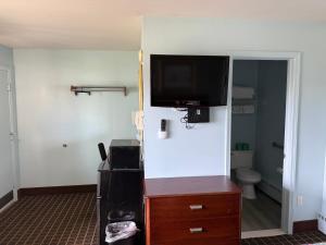 a room with a tv on the wall and a bathroom at Crow's Nest in Tawas City +17 photos