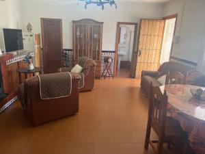 a living room with couches and a table at Rincón Subbético in Luque