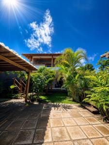 a house with a pathway in front of it at CASA SIMONI Trancoso in Trancoso