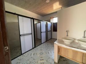 a bathroom with two sinks and two mirrors at Casona El Remanso in Mariquita +2 photos