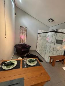 a living room with a table and a couch at Chalé Reserva El Paso in Mairiporã