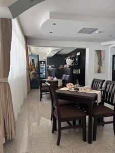 a dining room with a table and chairs in a restaurant at Motel Vatra Bunătăților in Brezoi