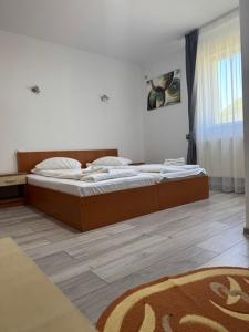 a bedroom with a bed in a room at Motel Vatra Bunătăților in Brezoi