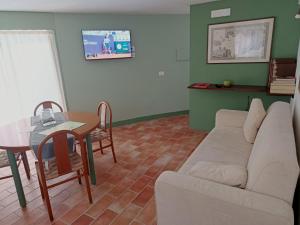 a living room with a couch and a table at GuestHouse Tana del Riccio Todi in Todi