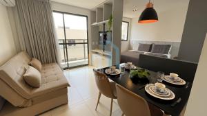 a dining room and living room with a table and chairs at Compact Tambaú Genius Flats in João Pessoa