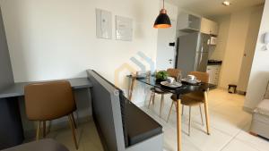 a kitchen with a table and chairs in a room at Compact Tambaú Genius Flats in João Pessoa +12 photos
