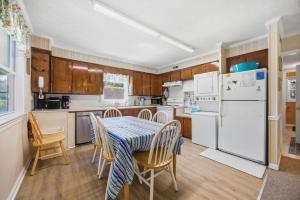 a kitchen with a table and chairs and a refrigerator at 7604 - Uncle Pooh's Cottage in Avon