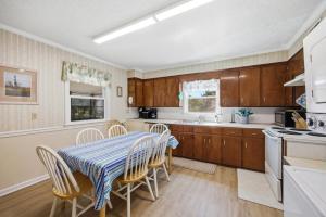 a kitchen with a table and chairs in a kitchen at 7604 - Uncle Pooh's Cottage in Avon