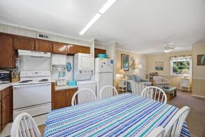 a kitchen and dining room with a table and chairs at 7604 - Uncle Pooh's Cottage in Avon +45 photos