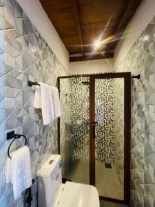 a bathroom with a shower and a toilet and towels at Villa Surf Beach in Galle +107 photos