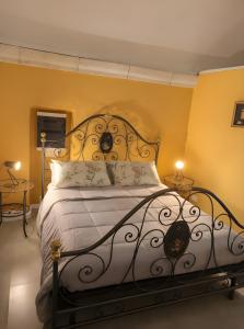a bedroom with a large bed with yellow walls at Casa Belvedere - A Due Passi Dal Centro - ItalyWeGo in Narni