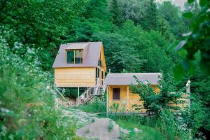 a wooden house in the middle of a forest at Cliffside - ქლიფსაიდი in Makhunts'et'i