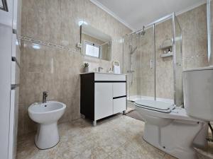 a bathroom with a toilet and a sink and a shower at SHR House in Porto Formoso +18 photos