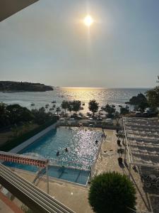 a swimming pool with a view of the ocean at Mercan Otel in Çanakkale