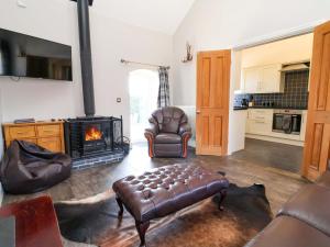 a living room with a couch and a fireplace at Clwyd Cottage in St Asaph