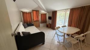 a living room with a bed and a table with a dining room at Arya Otel in Marmaris